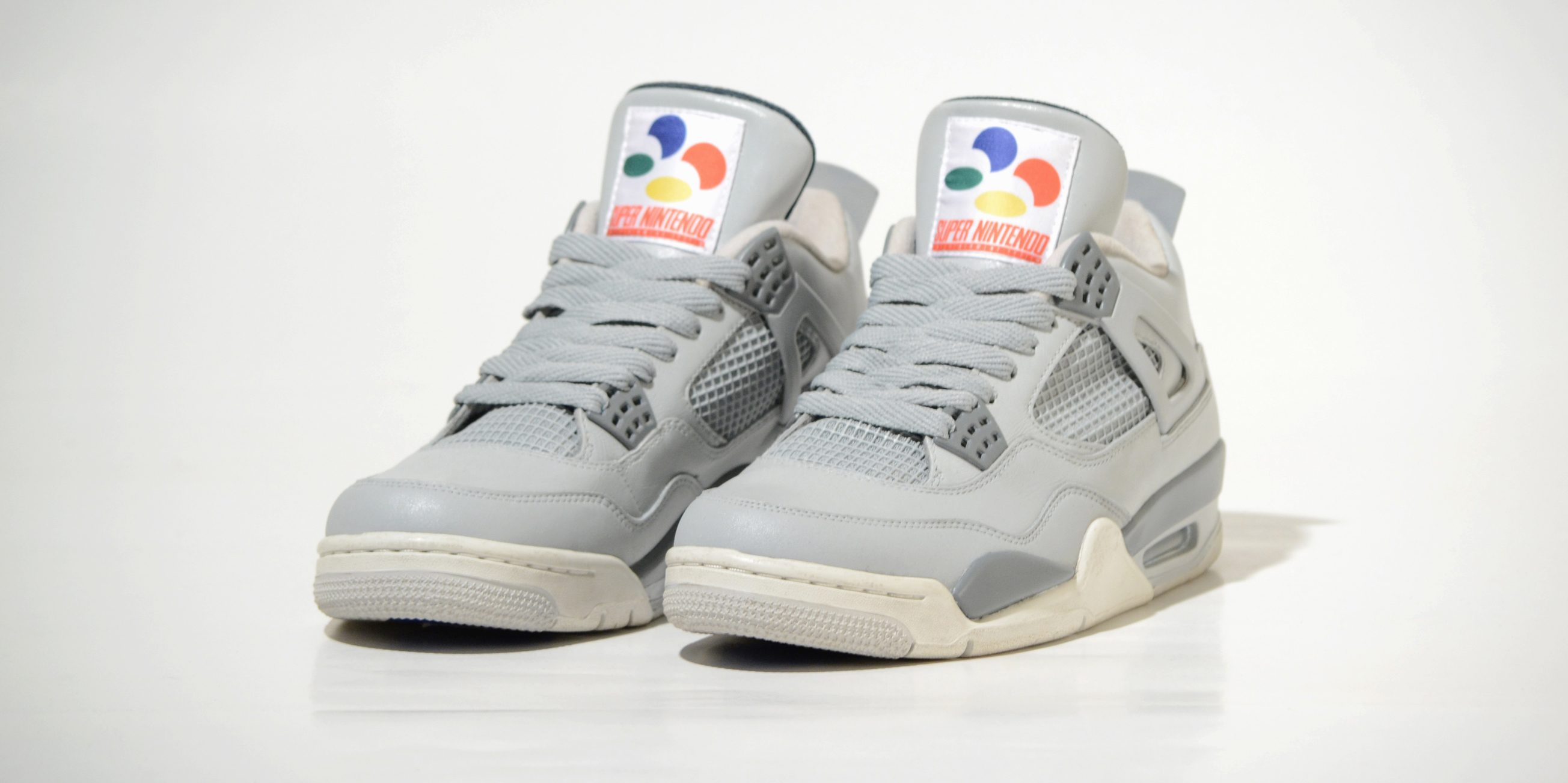 You absolutely have to check these custom Air Jordan 4 Super Nintendo sneakers