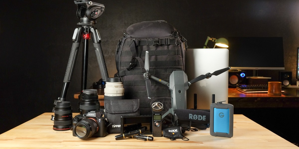 Camera backpack with equipment on table