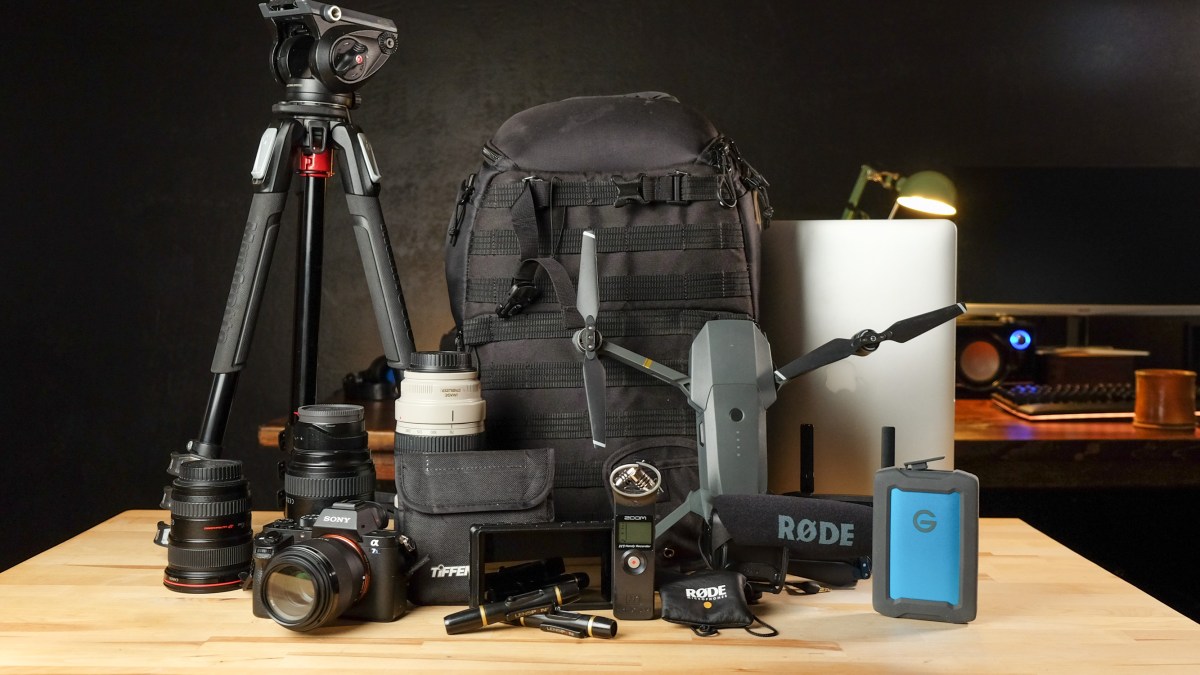 Camera backpack with equipment on table