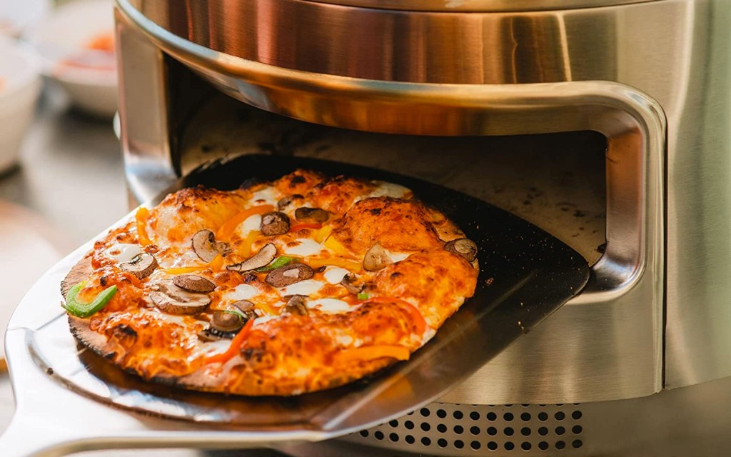 a pizza sitting on top of a pan on a stove