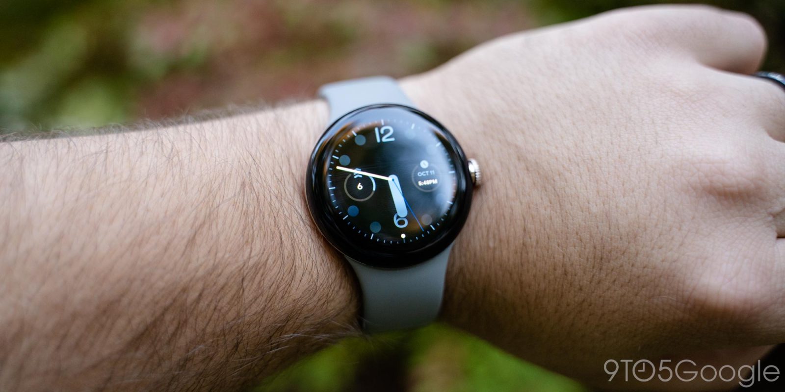 a close up of a person holding a watch