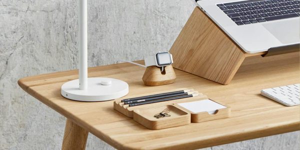 a laptop computer sitting on top of a wooden table