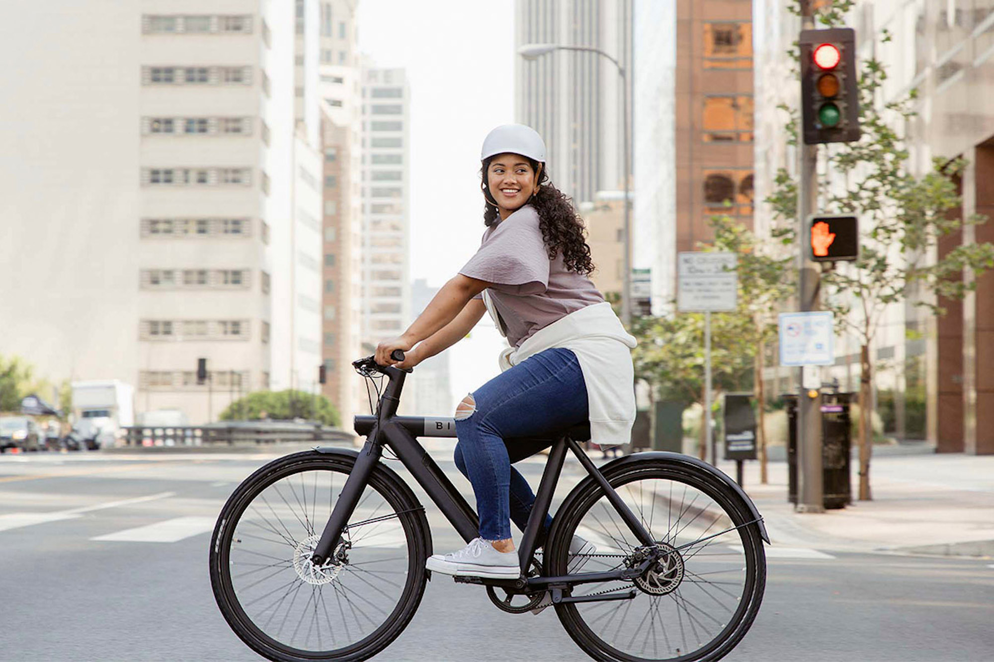 a woman riding a bicycle on a city street