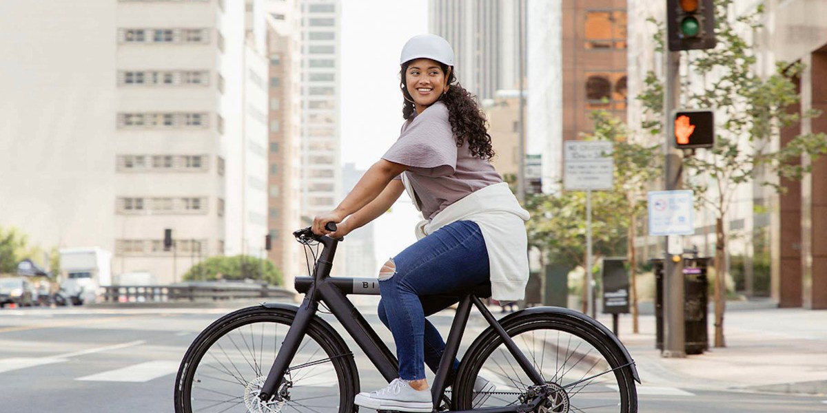 a woman riding a bicycle on a city street