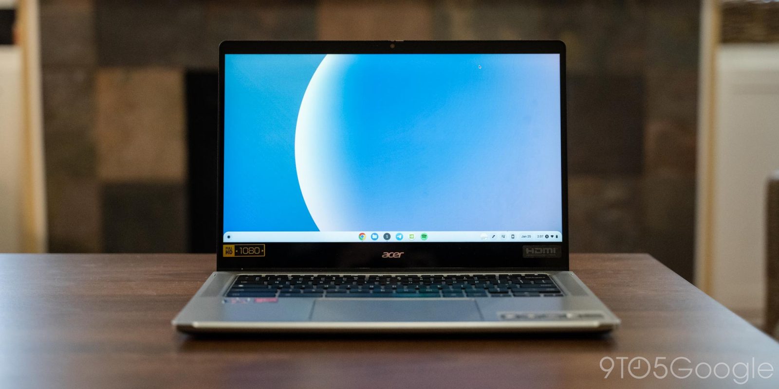 an open laptop computer sitting on top of a wooden table