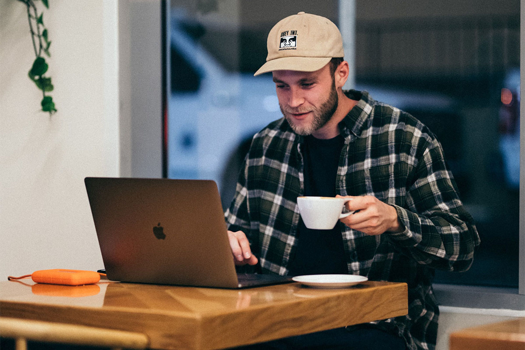 a man sitting at a table using a laptop