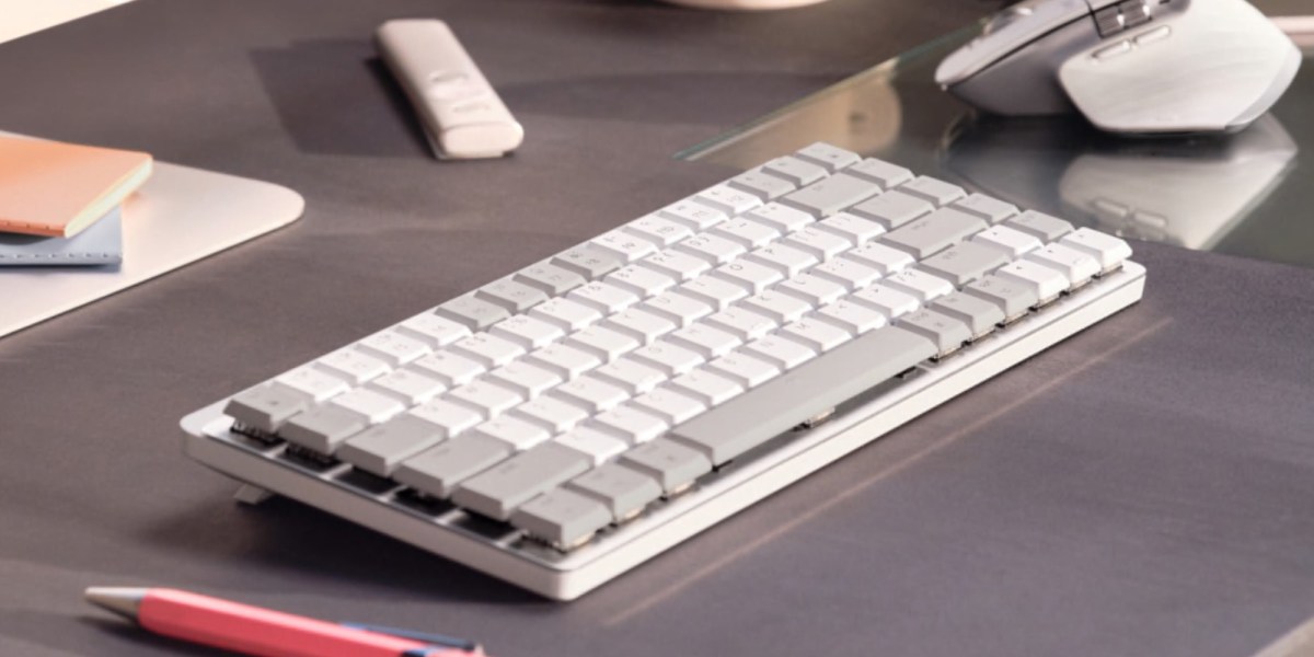 a desk with a computer mouse and keyboard