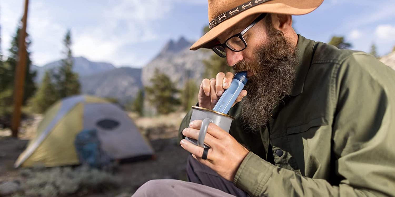 a man wearing a hat talking on a cell phone