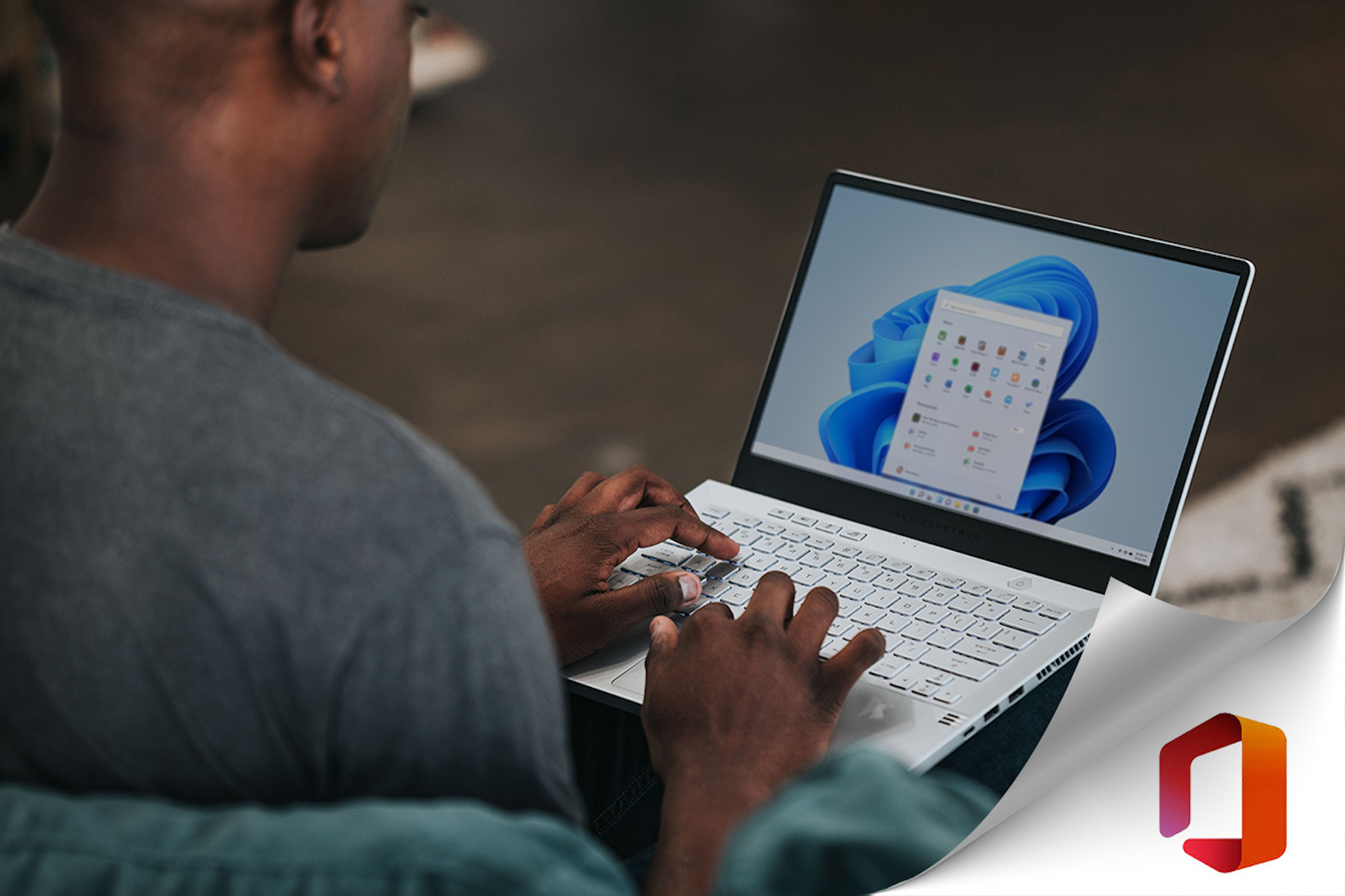 a man sitting at a table using a laptop