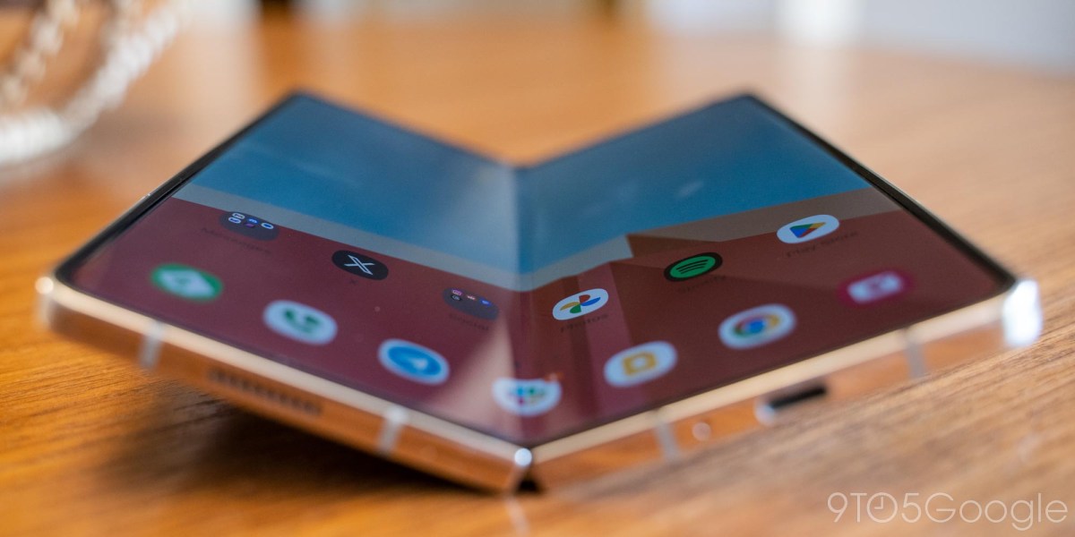a close up of a phone sitting on top of a wooden table