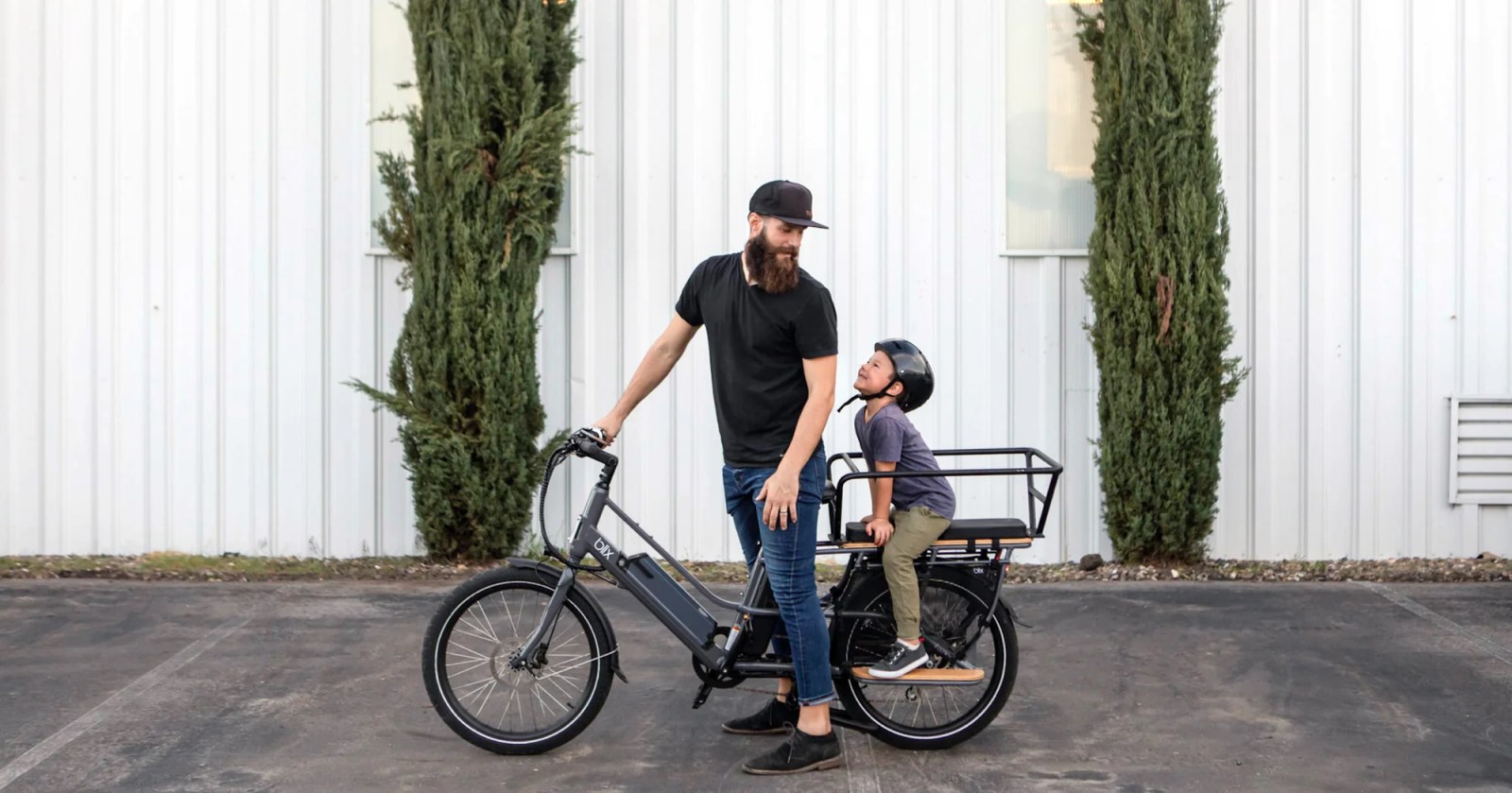 a man riding a bicycle in front of a building