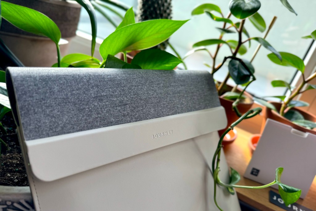 a laptop computer sitting on top of a green plant