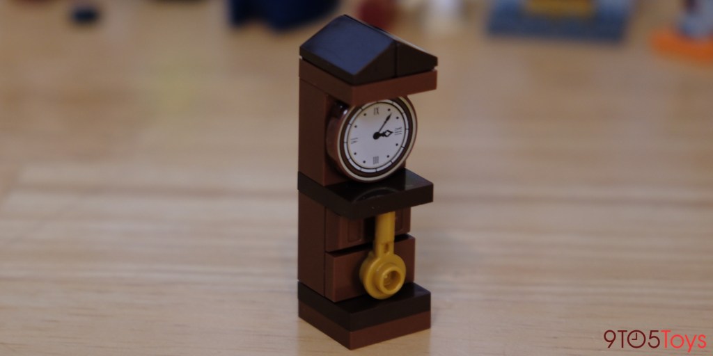 a clock sitting on top of a wooden table
