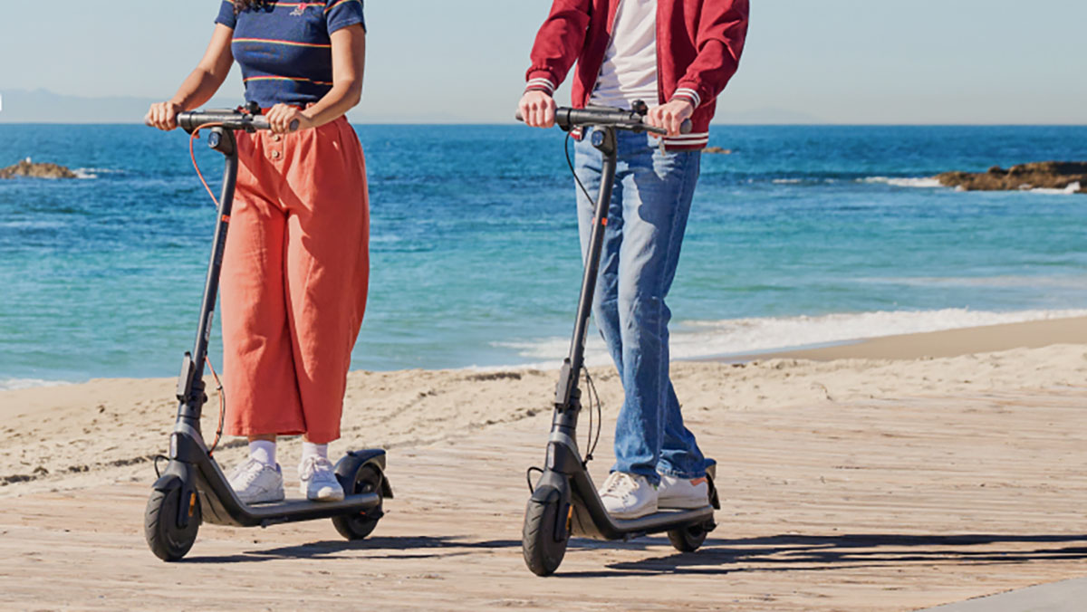 a couple of people that are standing in the sand on a beach