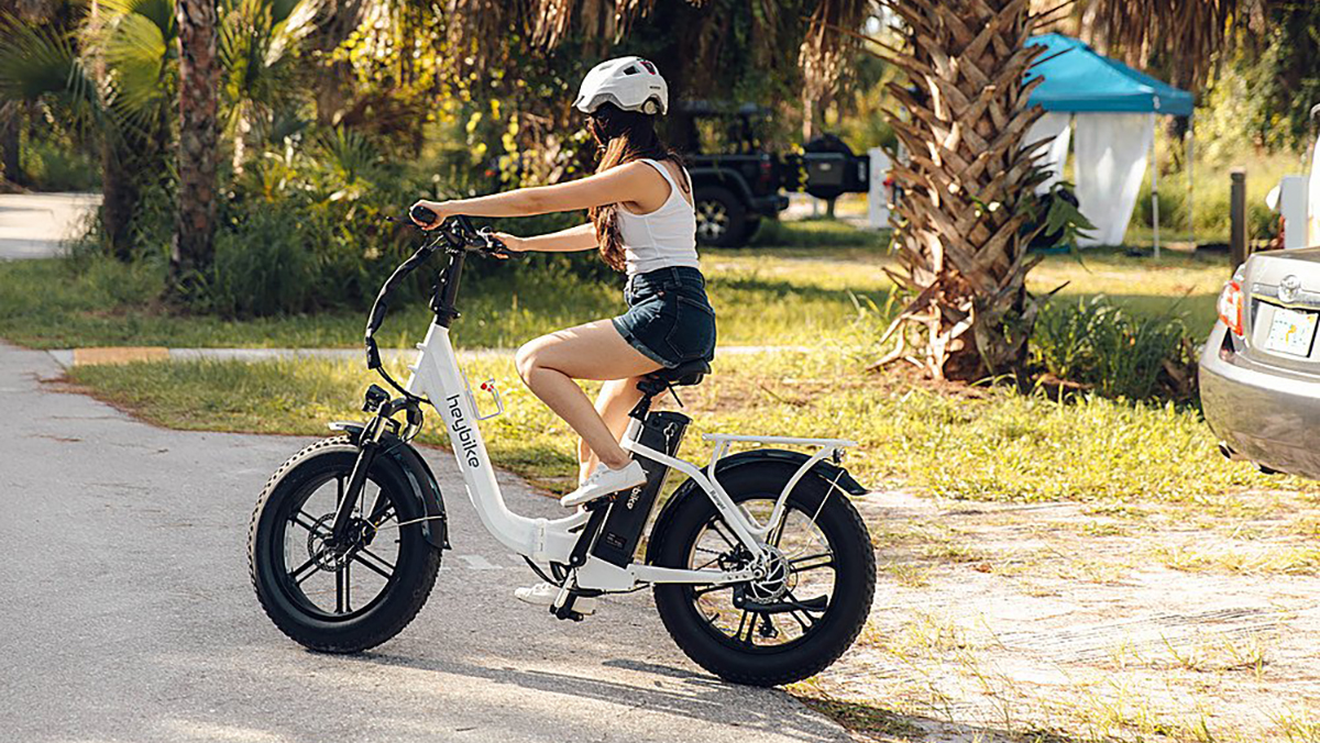 a person riding a bike down a dirt road