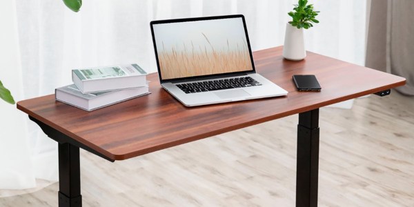 a desk with a laptop computer sitting on top of a wooden table