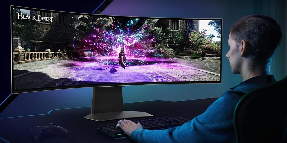 a man sitting at a desk in front of a computer screen