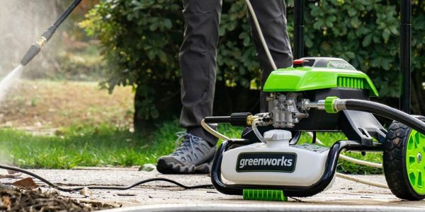 a person standing next to a lawn mower