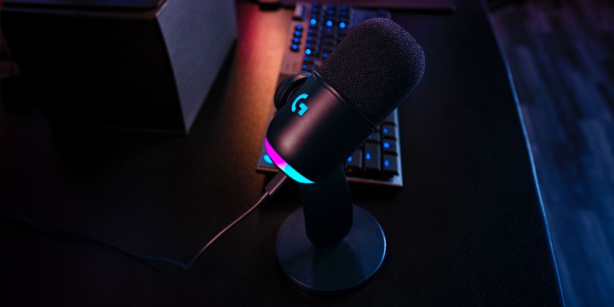 Logitech G Yeti GX mic with RGB lighting kept on a table next to other peripherals.