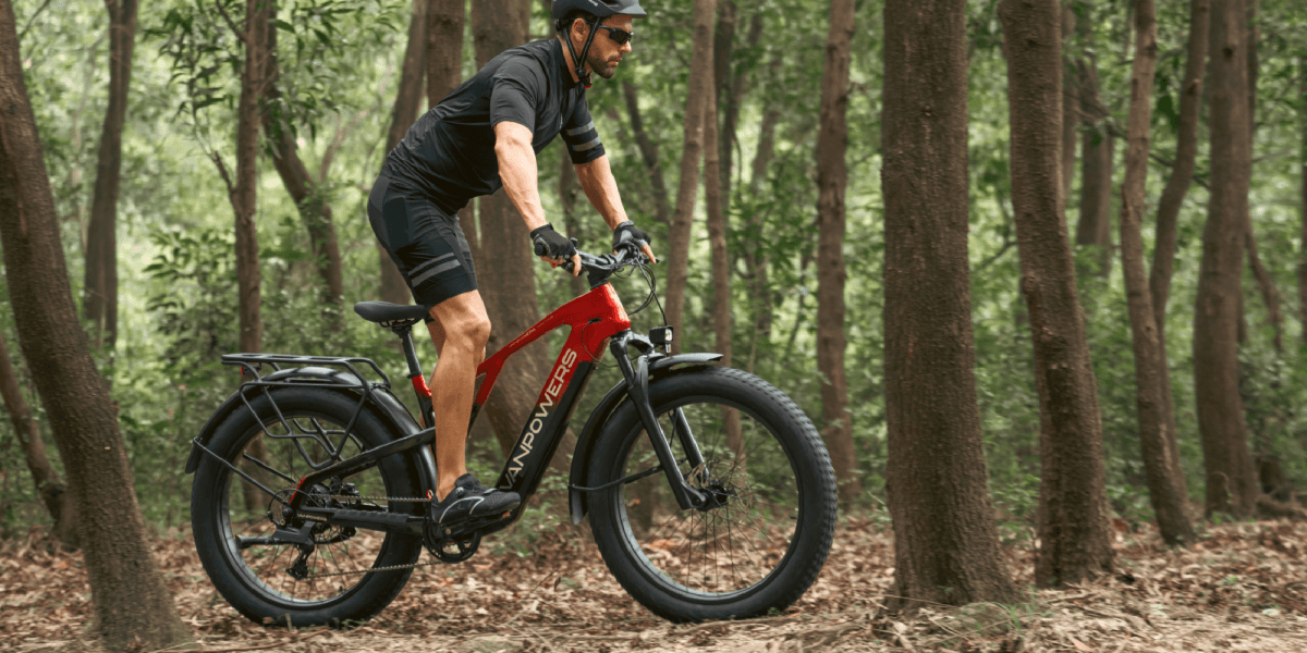 a man riding a bike in the woods