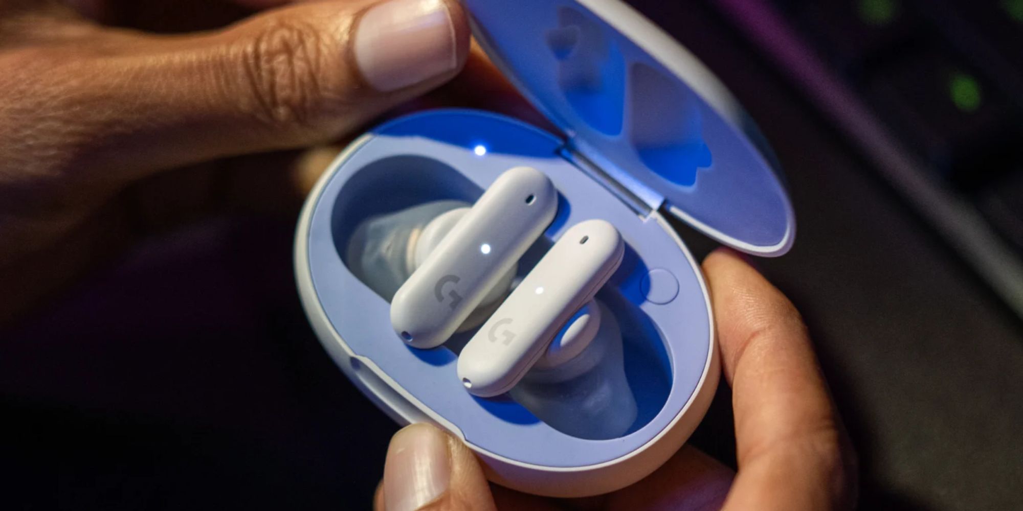 A pair of Logitech G FITS wireless earbuds in their charging case.