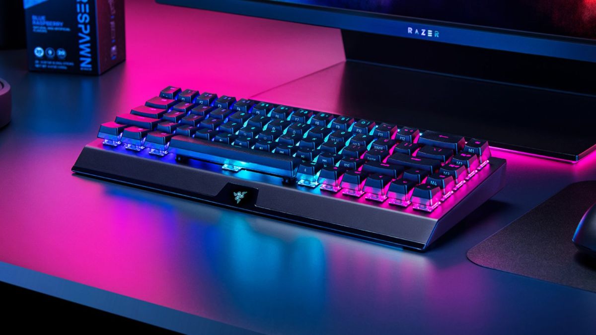 An image showing a Razer BlackWidow V3 Mini wireless gaming keyboard on a desk.