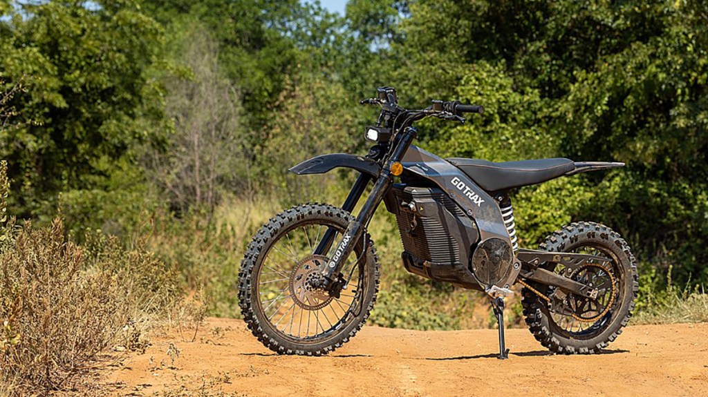 a motorcycle parked on a dirt road