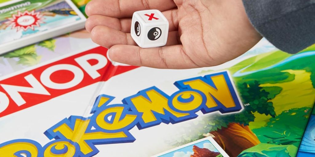 Image showing a person throwing dice over Pokemon Monopoly game.