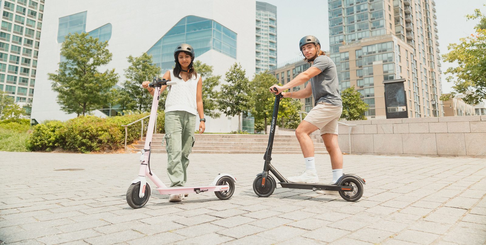 a man and a woman on segways in front of a building