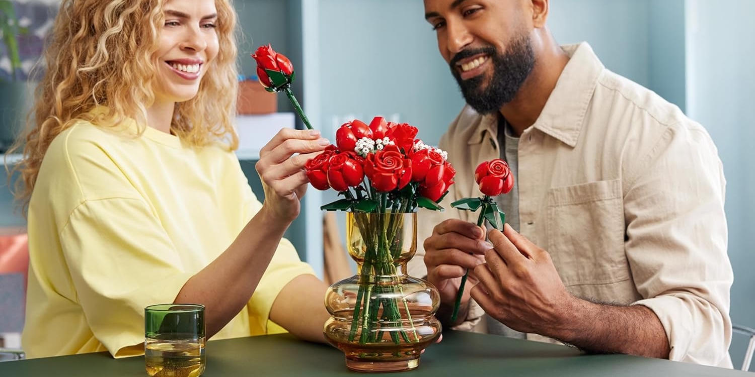 a man and a woman holding flowers