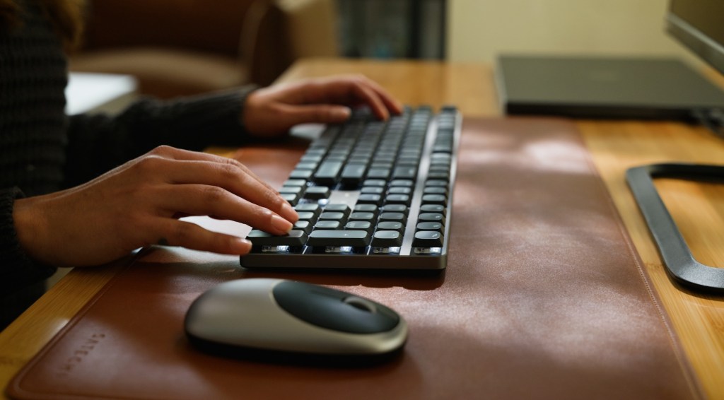 a person typing on a keyboard