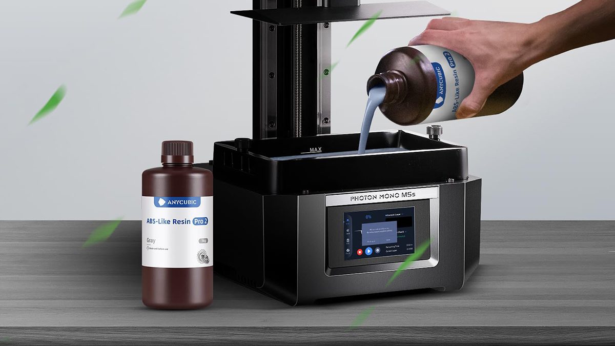 A hand pouring liquid into a machine