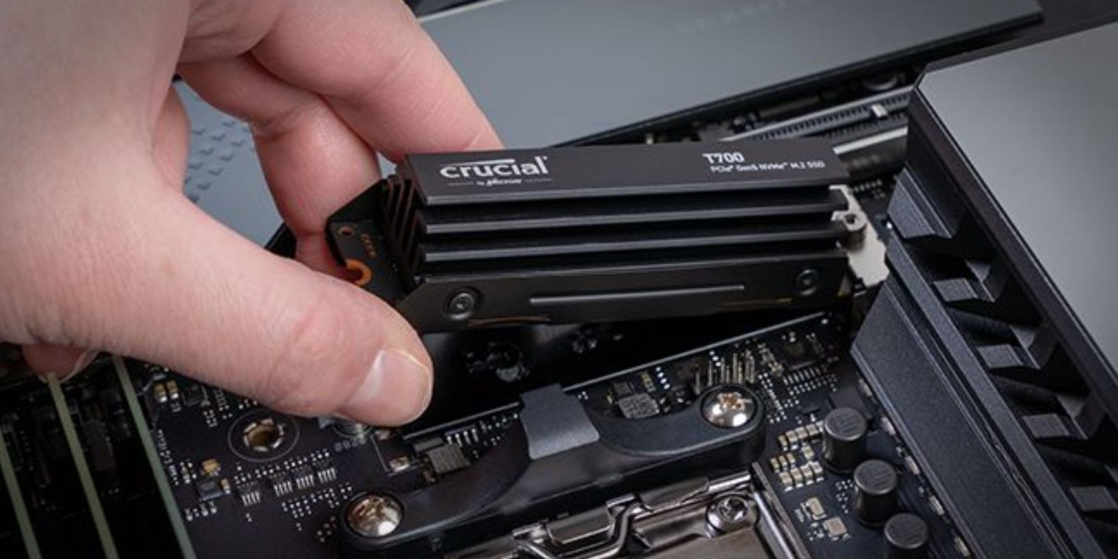 Image showing a person installing Crucial's T700 Gen 5 SSD.