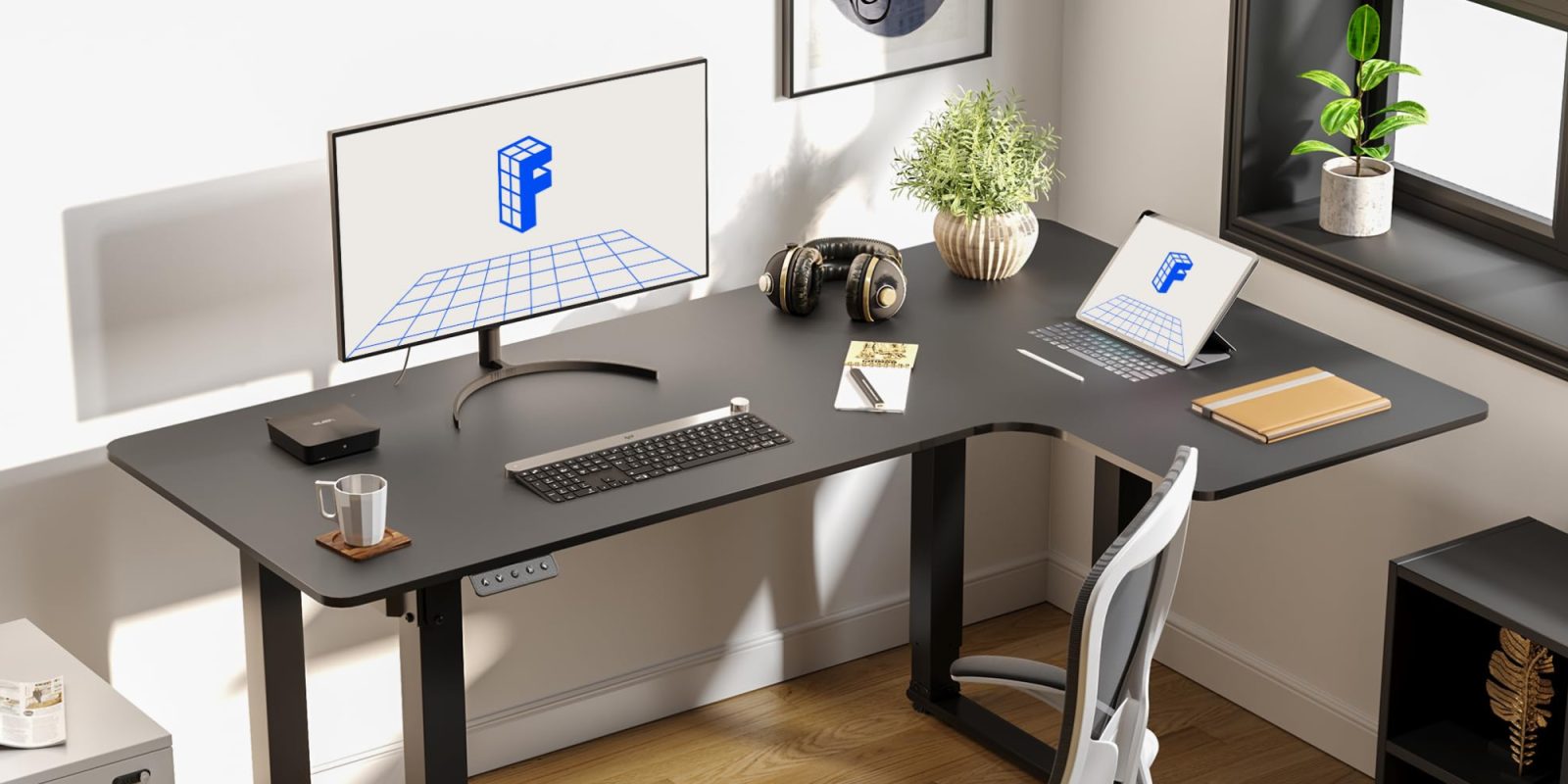 A desk with a computer and a plant on it