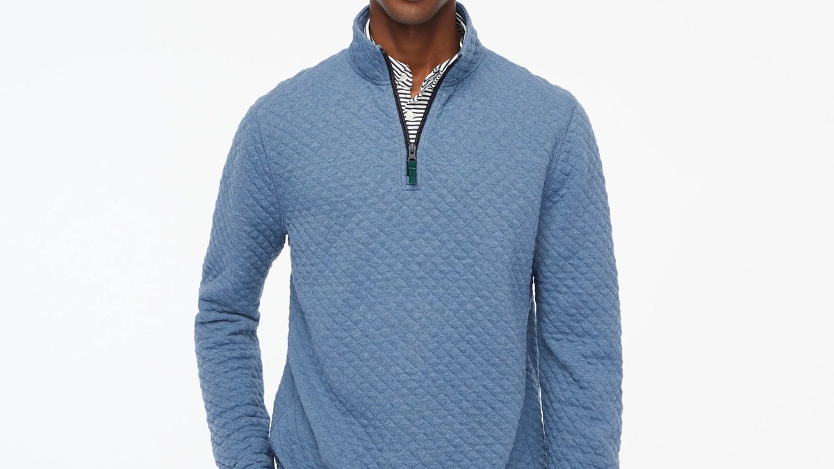 A man wearing a blue sweater