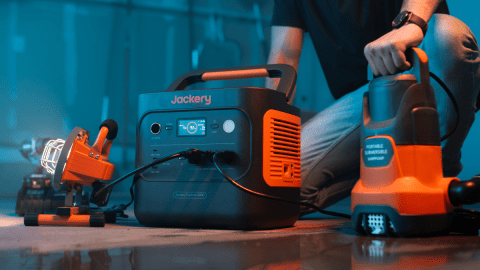 A person sitting on the floor next to a machine