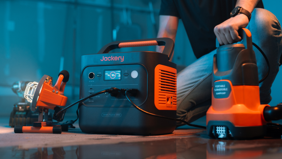 A person sitting on the floor next to a machine
