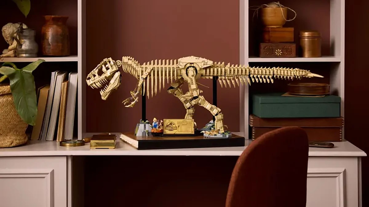 A toy dinosaur on a shelf