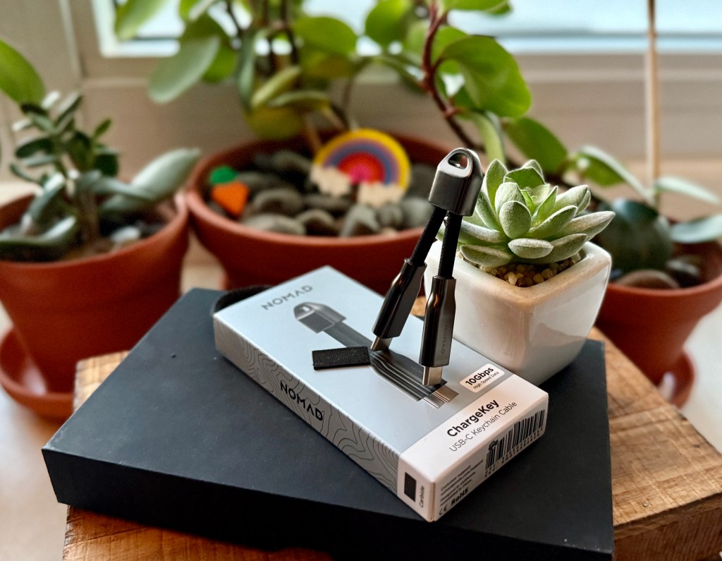 A small box with a pair of compasses on top of it