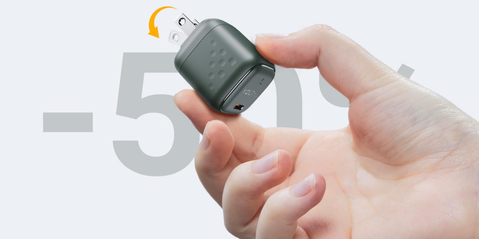 A hand holding a small device