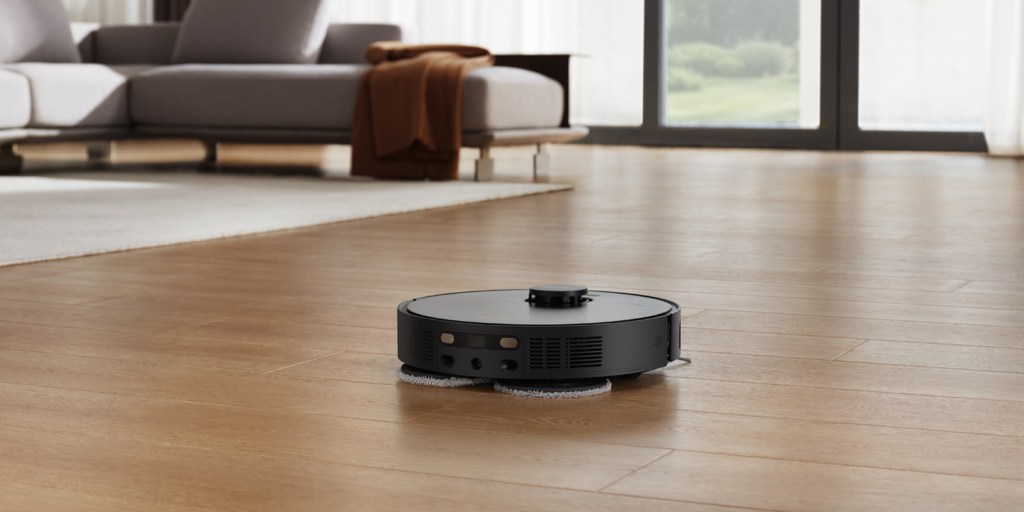 A robot vacuum cleaner on a wood floor