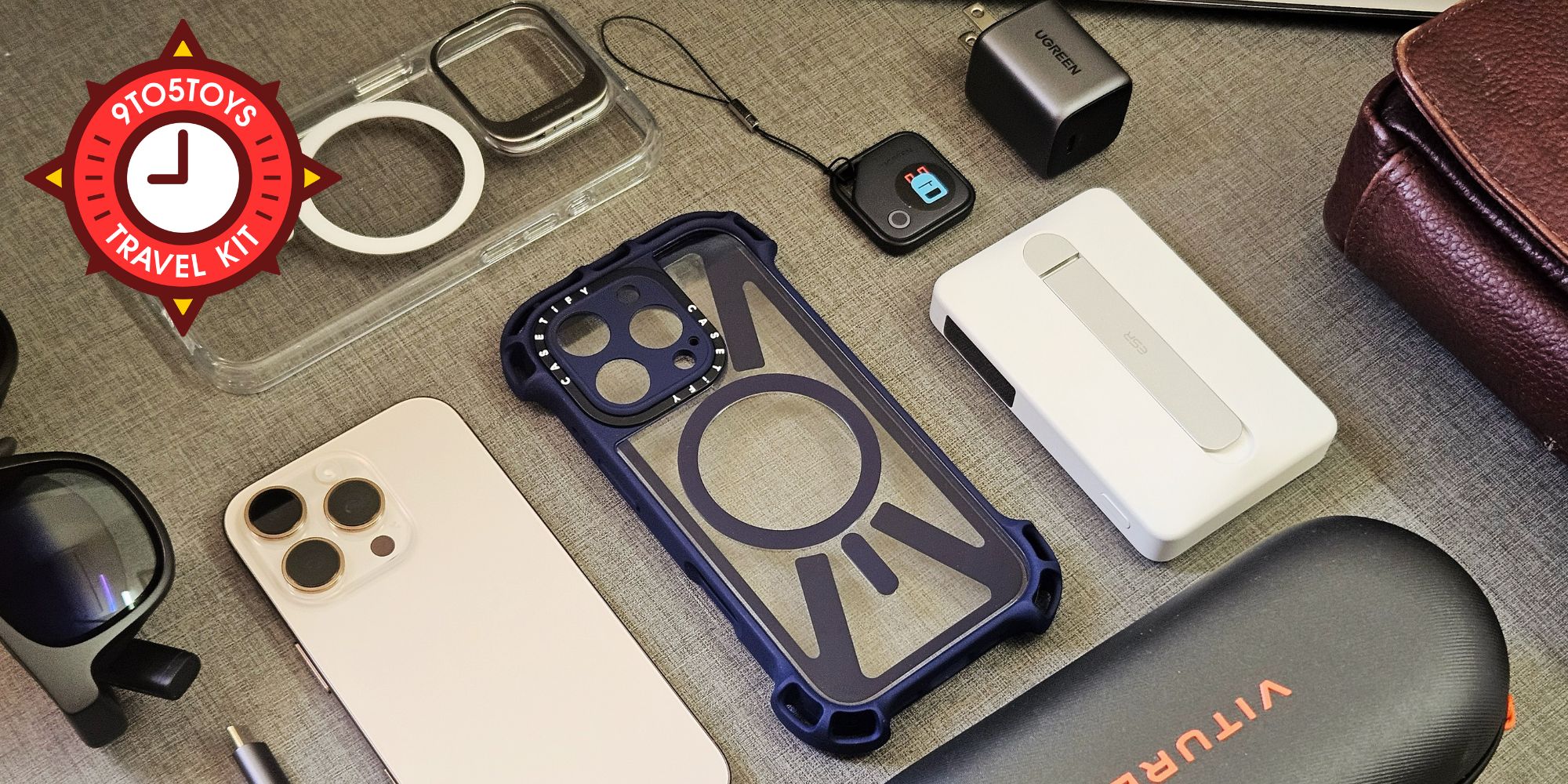 A flat lay image showing a bunch of gear on a desk.