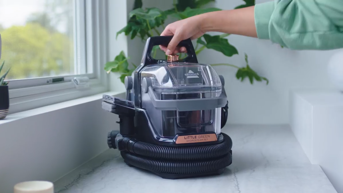 A person holding a vacuum cleaner