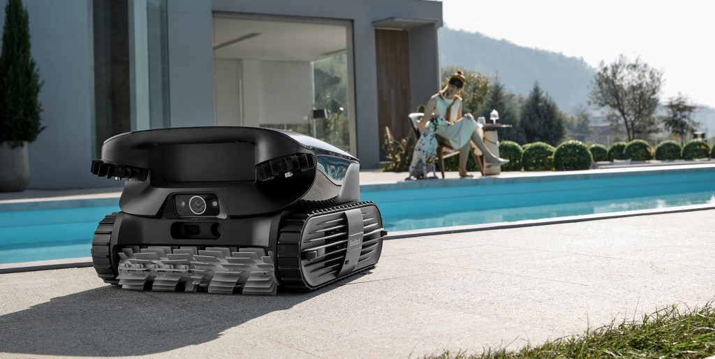 A robot on the ground by a pool