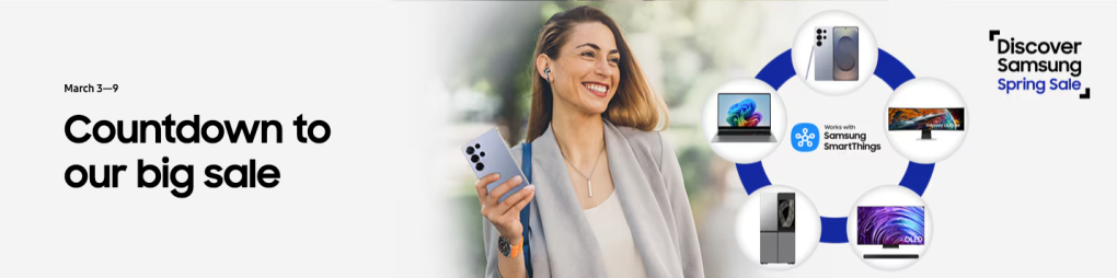 A woman smiling while holding a phone