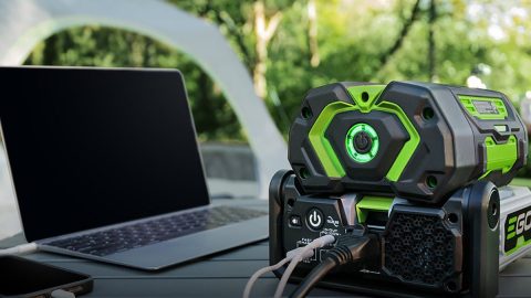 A black and green device with a laptop