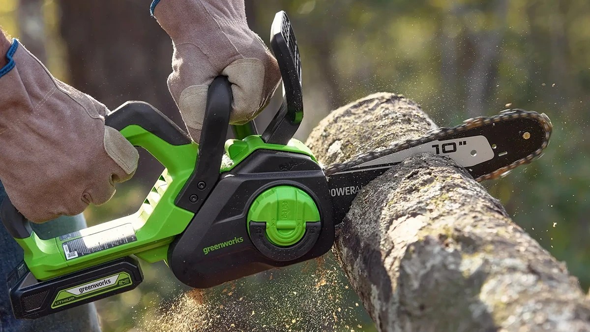 A hand holding a chainsaw