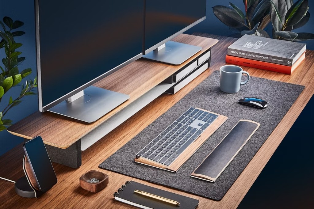 A desk with a computer monitor and a mug on it