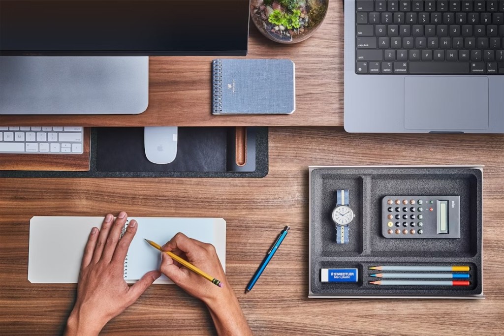 A person writing on a notebook