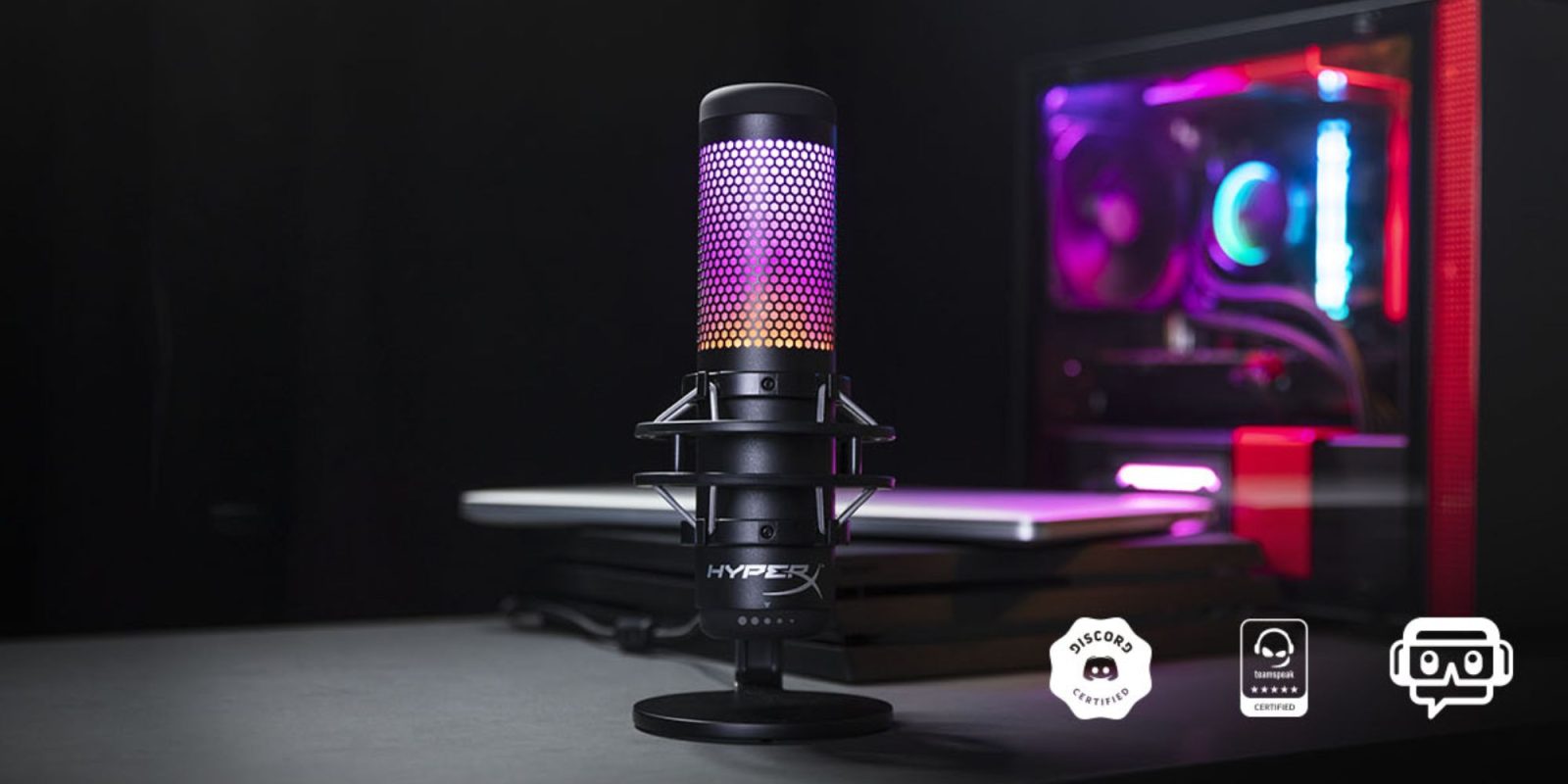 A black microphone with a purple and pink light.
